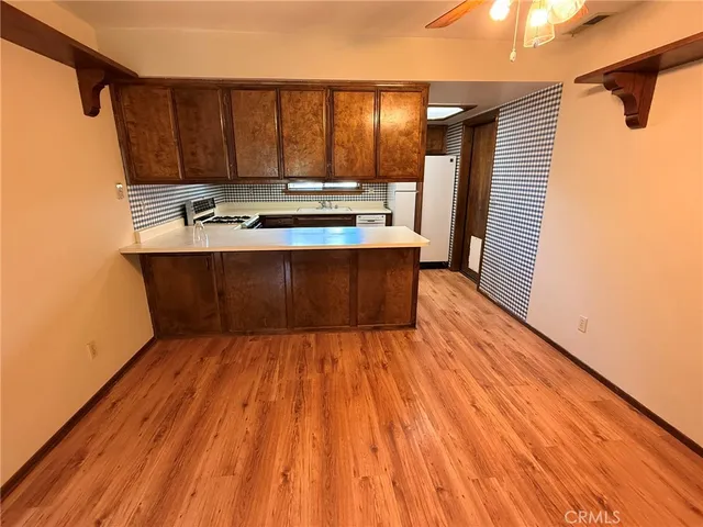 a room with wooden floor and furniture