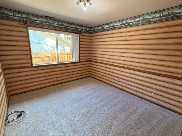 a view of a room with window and a ceiling fan