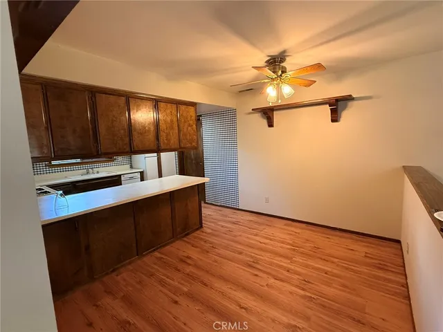 a view of kitchen with cabinets and wooden floor