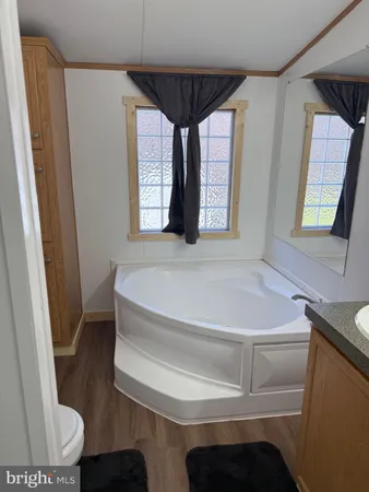 a bathroom with a bathtub and a window