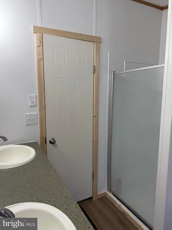a bathroom with a granite countertop toilet and a sink