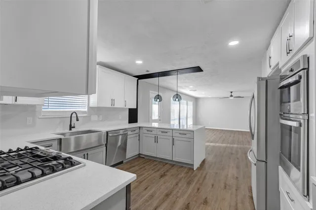 a kitchen with white cabinets and a stove