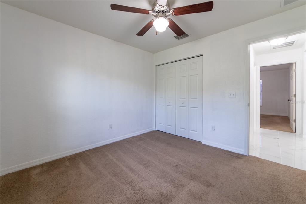 5107 Southwest 165th St Road Ocala, FL 34473 - Photo 23 of 34 an empty room with closet and fan