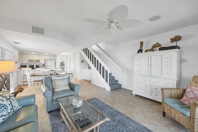 a living room with furniture and a view of kitchen
