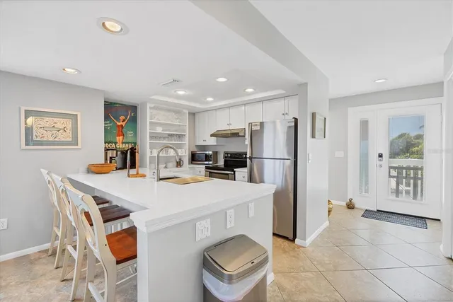 a kitchen with stainless steel appliances a refrigerator and a stove top oven