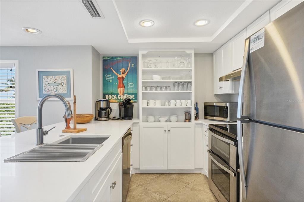 420 Gulf Boulevard, Unit 13 Boca Grande, FL 33921 - Photo 15 of 36 a kitchen that has a refrigerator and a sink