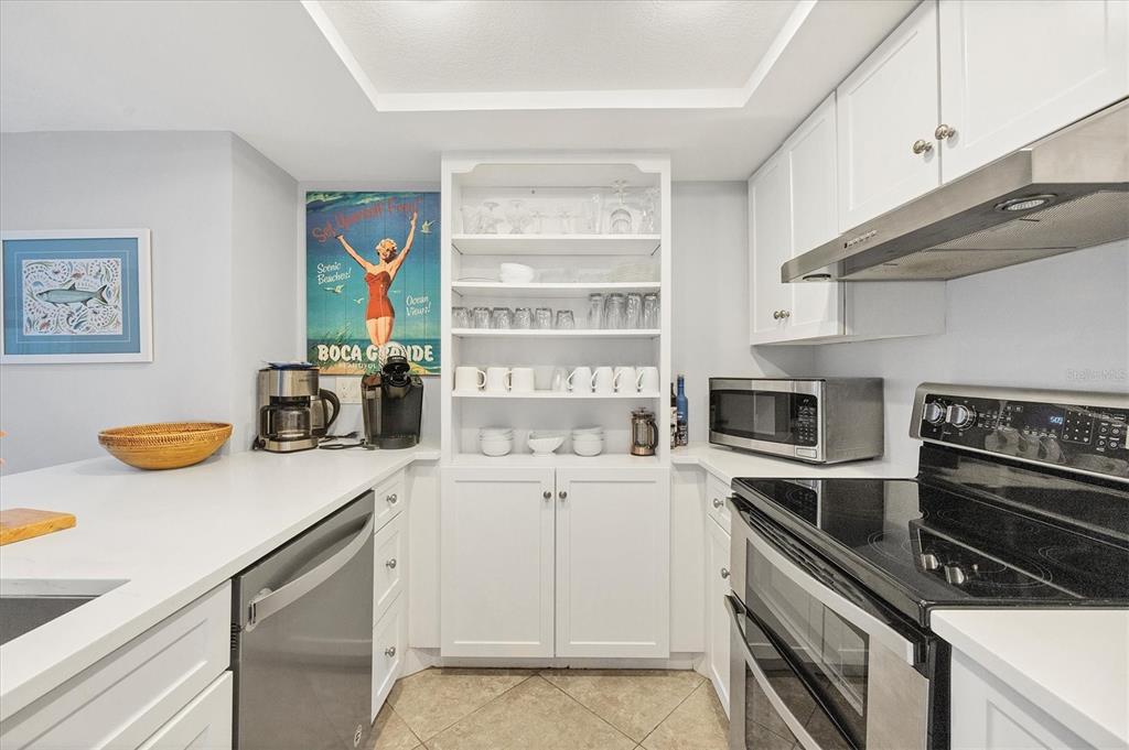 420 Gulf Boulevard, Unit 13 Boca Grande, FL 33921 - Photo 16 of 36 a kitchen with a sink appliances and cabinets