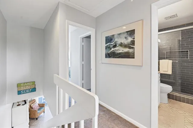 a view of a hallway with paintings on the wall