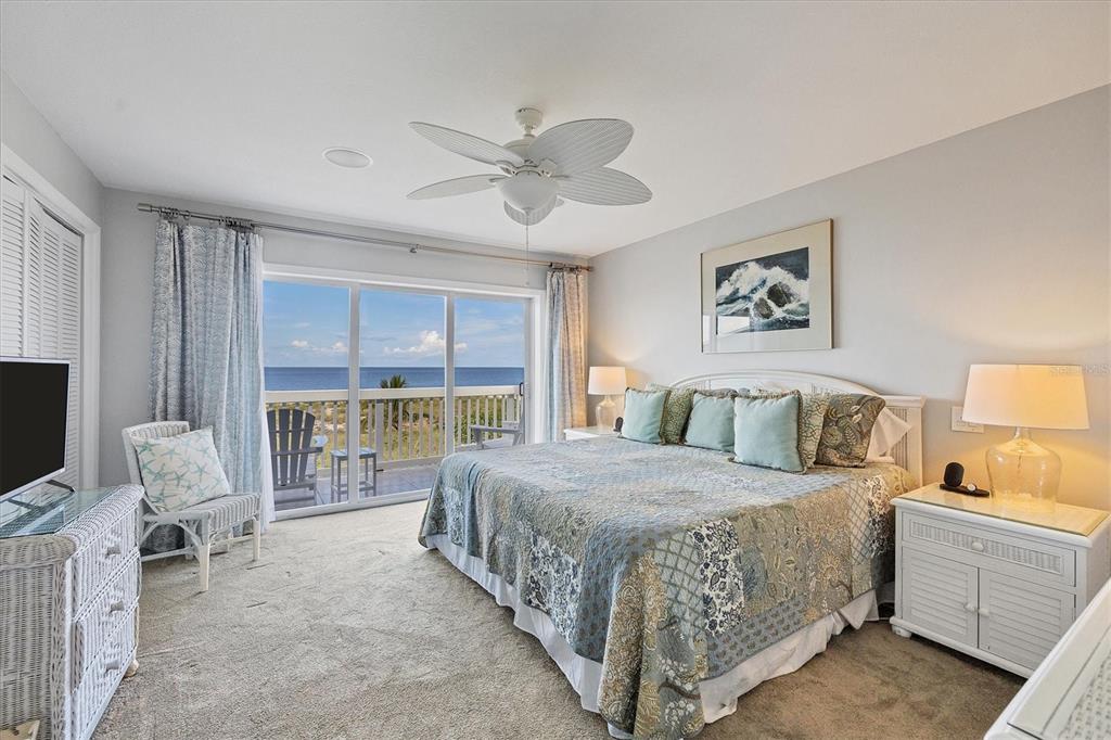 420 Gulf Boulevard, Unit 13 Boca Grande, FL 33921 - Photo 23 of 36 a bedroom with a bed and a couch