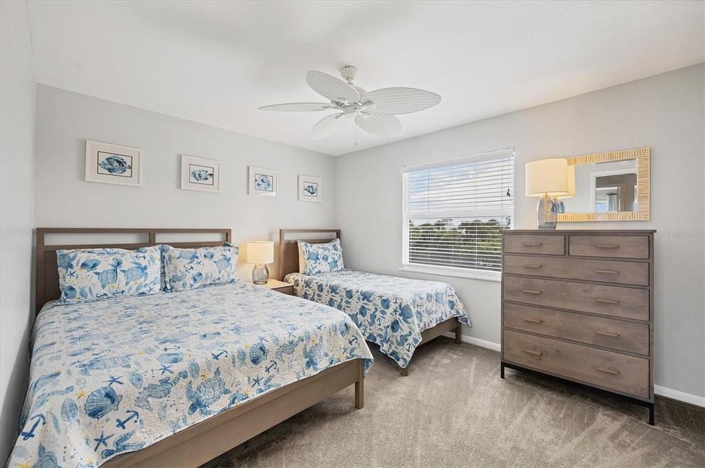 420 Gulf Boulevard, Unit 13 Boca Grande, FL 33921 - Photo 27 of 36 a bedroom with a bed and a dresser