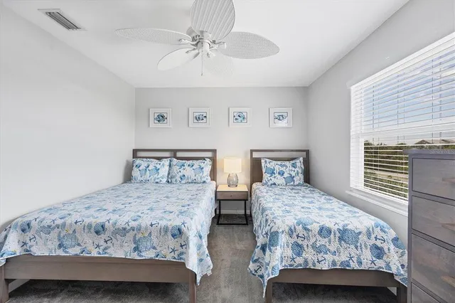 a bedroom with two beds and a chandelier