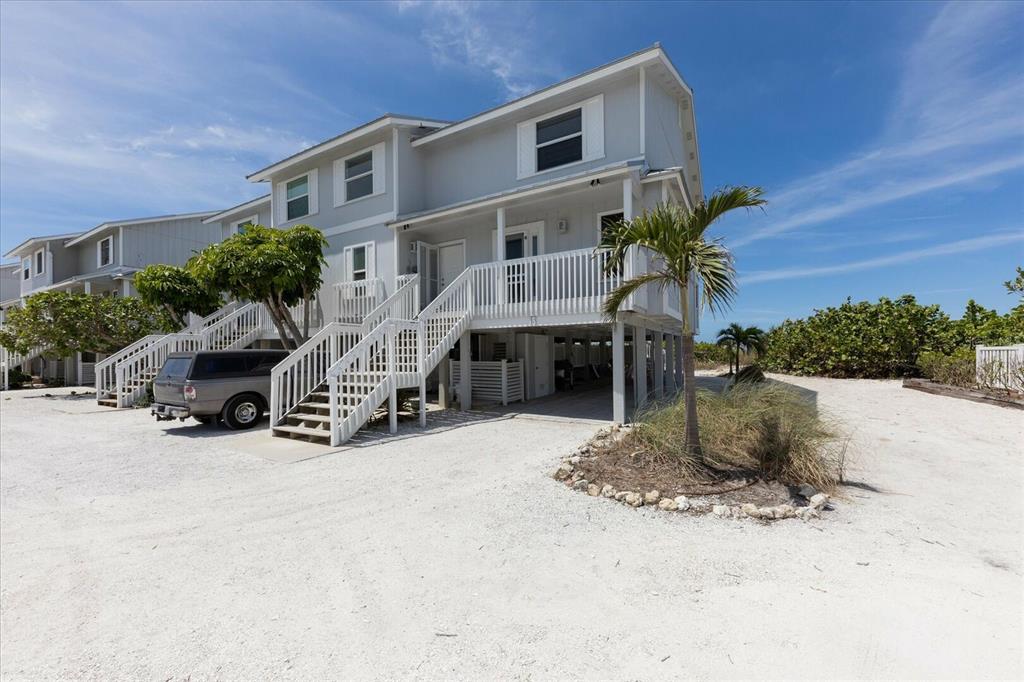 420 Gulf Boulevard, Unit 13 Boca Grande, FL 33921 - Photo 34 of 36 a front view of a house with a yard