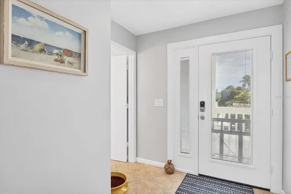 a view of a bedroom with wooden floor and windows