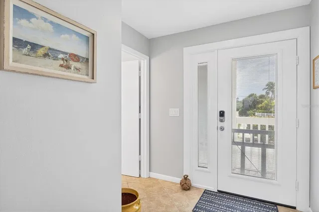 a view of a bedroom with wooden floor and windows