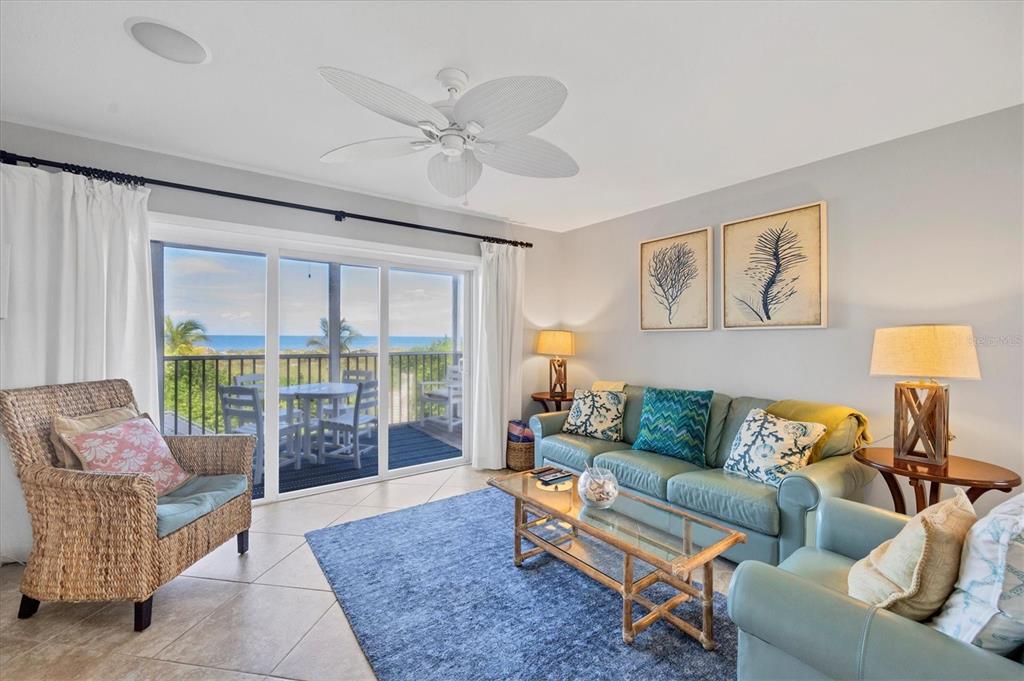 420 Gulf Boulevard, Unit 13 Boca Grande, FL 33921 - Photo 9 of 36 a living room with furniture and a floor to ceiling window