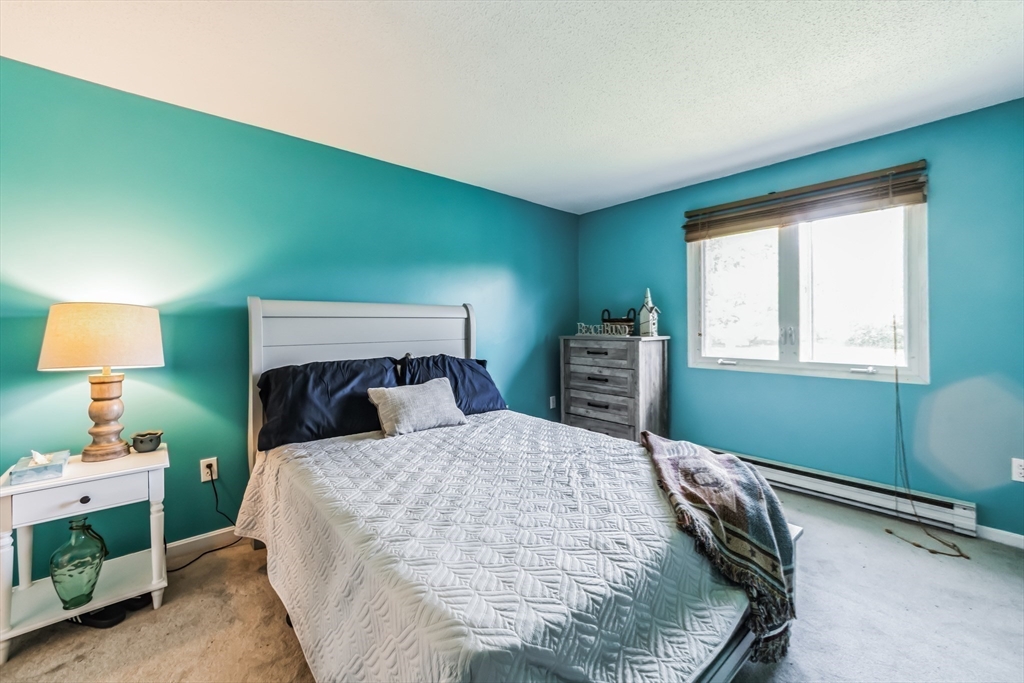 59 Seabury, Unit 59 Hampton, NH 03842 - Photo 18 of 25 a bedroom with a bed and a window
