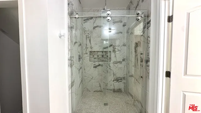 a bathroom with a shower and a sink