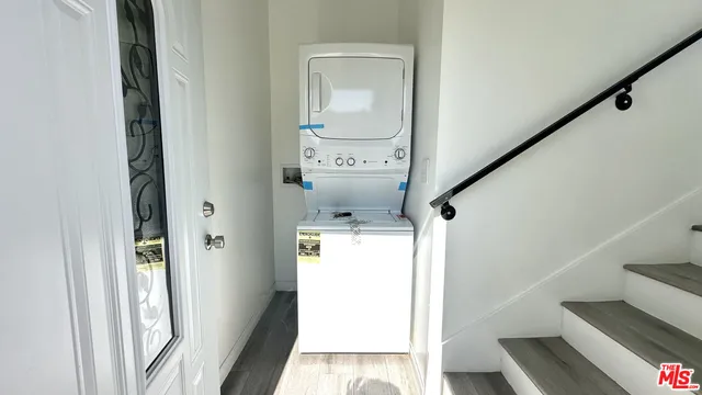 a view of a hallway with two white cabinets and a floor to ceiling window