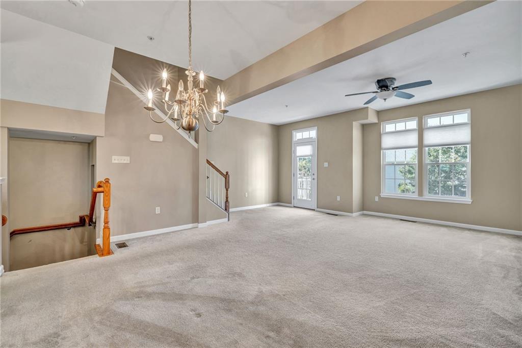 204 Hounslow Road Cranberry Township, PA 16066 - Photo 8 of 24 a view of a livingroom with a chandelier fan and windows