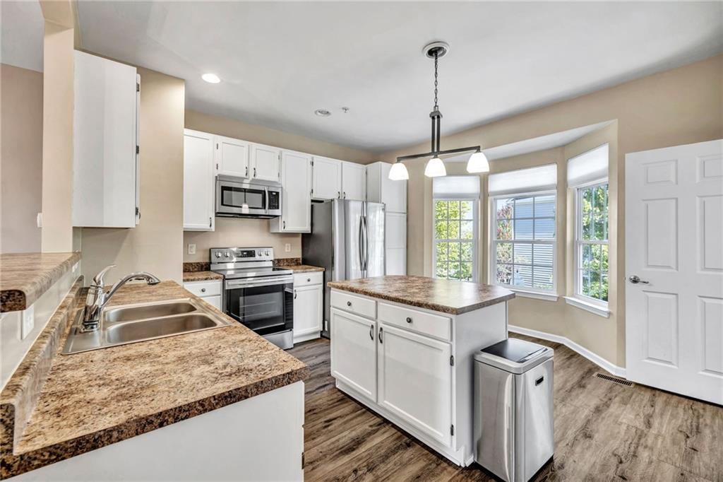 204 Hounslow Road Cranberry Township, PA 16066 - Photo 9 of 24 a kitchen with kitchen island granite countertop a stove sink and microwave
