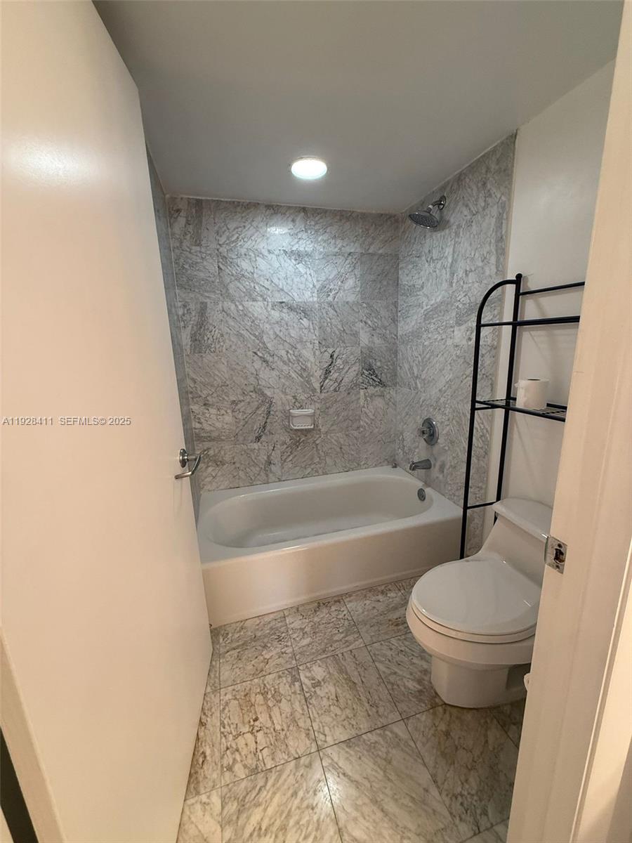 8911 Collins Avenue, Unit 1103 Surfside, FL 33154 - Photo 12 of 19 a bathroom with a toilet and a shower