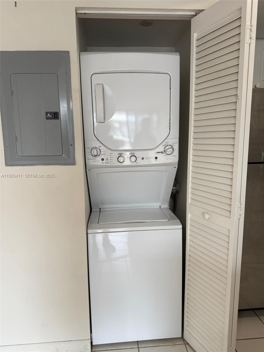 8911 Collins Avenue, Unit 1103 Surfside, FL 33154 - Photo 13 of 19 a utility room with dryer and washer