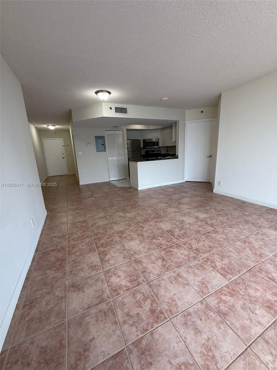 8911 Collins Avenue, Unit 1103 Surfside, FL 33154 - Photo 5 of 19 a view of a kitchen with a sink and a stove top oven