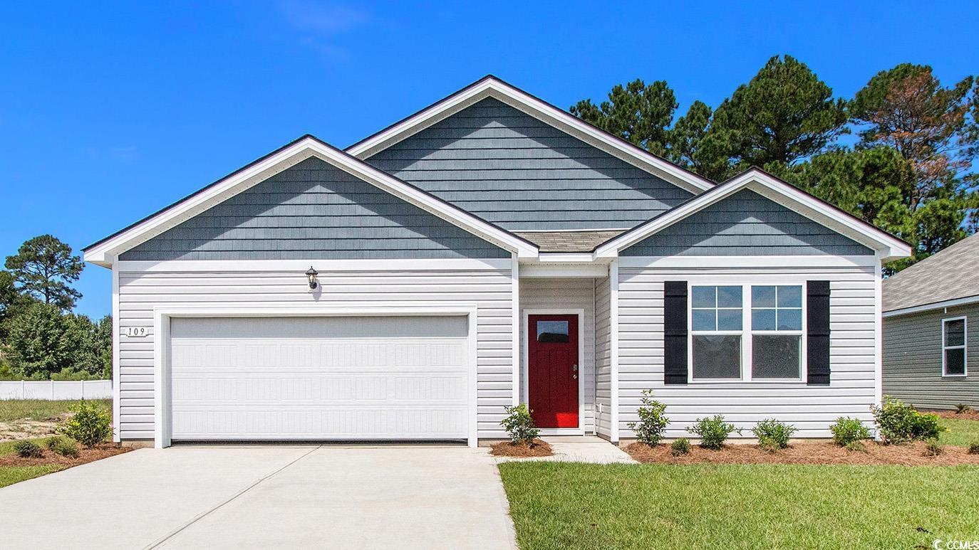 View of front of house with concrete driveway, an attached garage, and a front yard