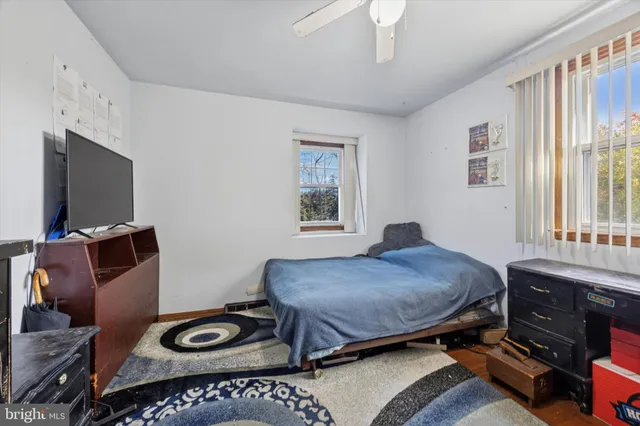 a bedroom with a bed and a tv