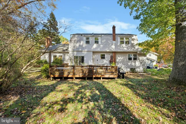 a view of a big house with a big yard and large trees
