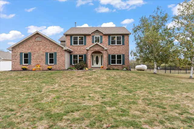 a kitchen with stainless steel appliances granite countertop a stove a refrigerator and a sink