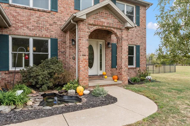 a view of empty room with wooden floor and window