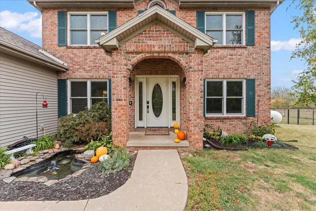 a kitchen with stainless steel appliances kitchen island granite countertop a refrigerator and a stove top oven