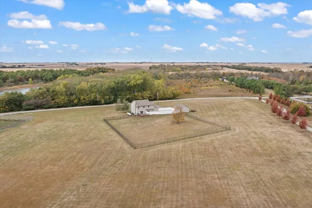 a view of empty room with wooden floor and window