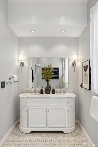 a bathroom with a double vanity sink and a mirror