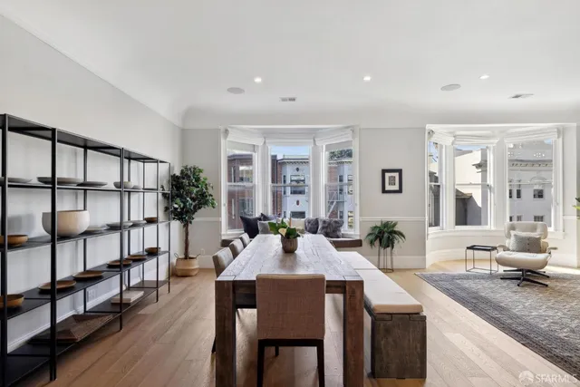 a view of a a dining room with furniture window and wooden floor