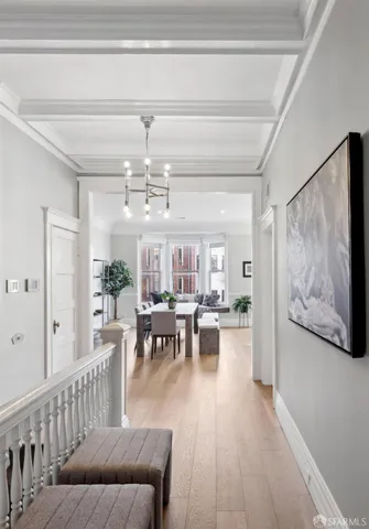 a kitchen with stainless steel appliances a stove a sink a refrigerator a window and white cabinets