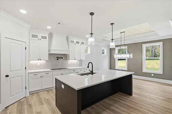 a bathroom with a granite countertop sink a toilet and mirror