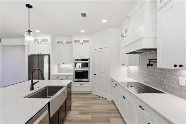 a view of staircase with white walls and white door