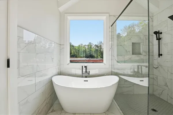 a bathroom with a granite countertop sink a toilet and a bathtub