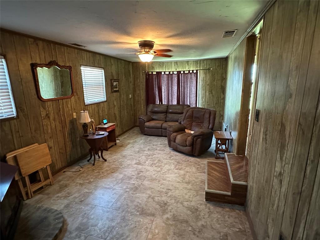 6551 Crooked Creek Road Bowie, TX 76230 - Photo 15 of 39 a living room with furniture and a mirror