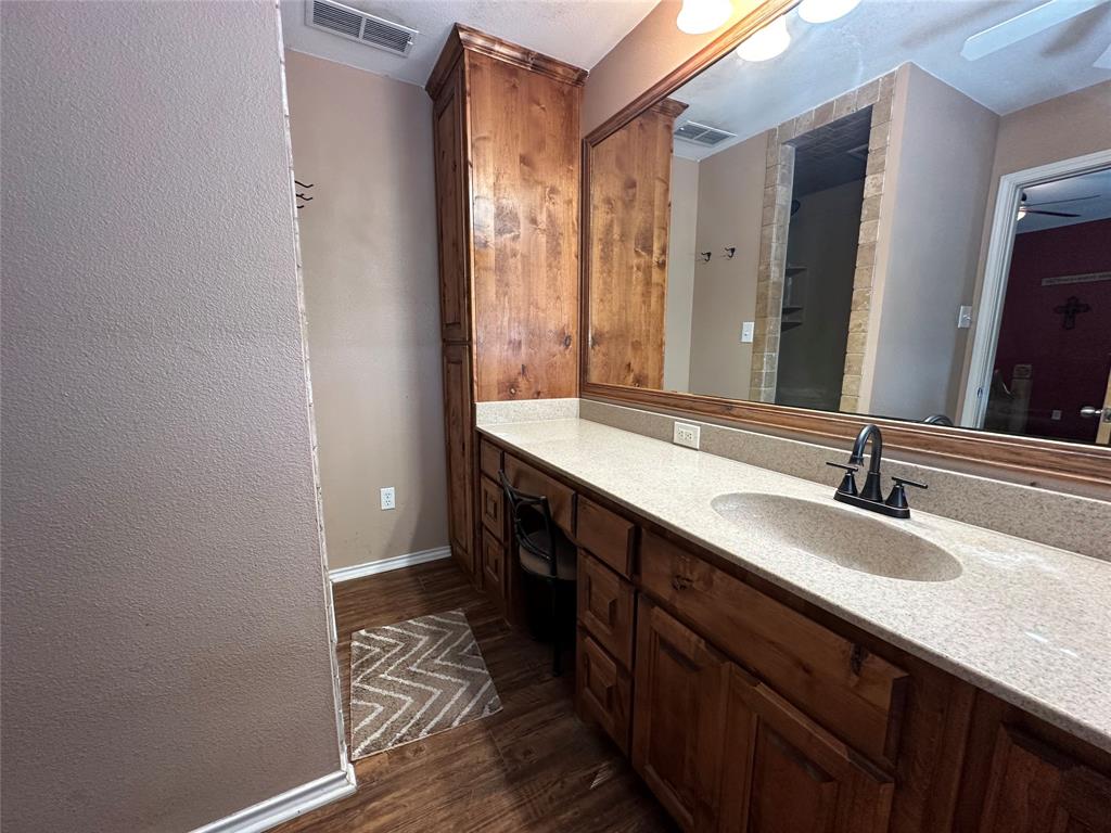 6551 Crooked Creek Road Bowie, TX 76230 - Photo 22 of 39 a bathroom with a double vanity sink and a mirror