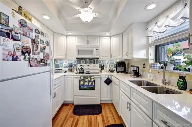 a kitchen with a white cabinets and white appliances