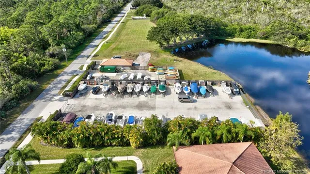 an aerial view of a house with a yard and lake view