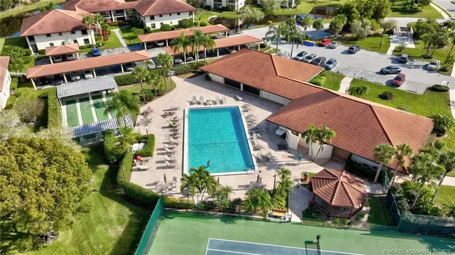 an aerial view of multiple houses with yard