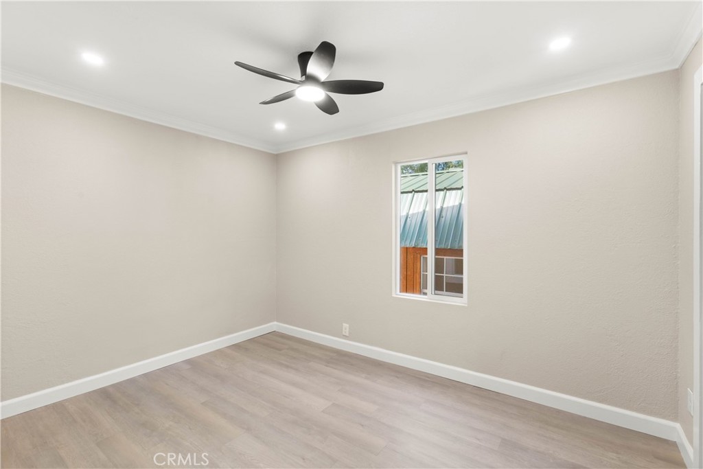 4936 Lower Wyandotte Road Oroville, CA 95966 - Photo 13 of 41 an empty room with a window and a fan