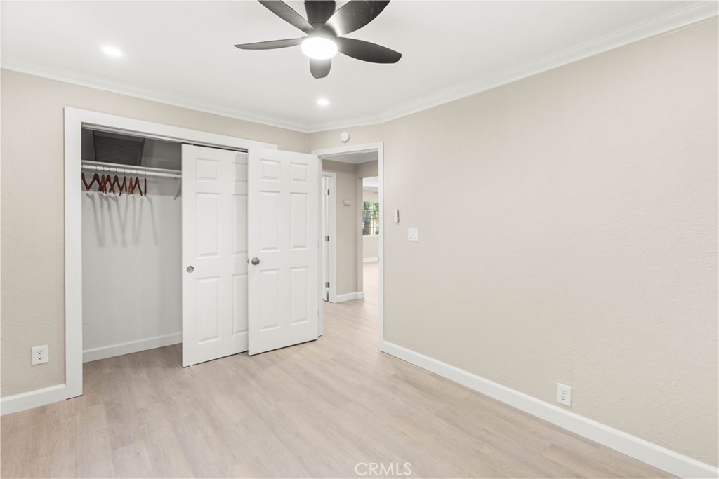 4936 Lower Wyandotte Road Oroville, CA 95966 - Photo 14 of 41 an empty room with a ceiling fan and carpet