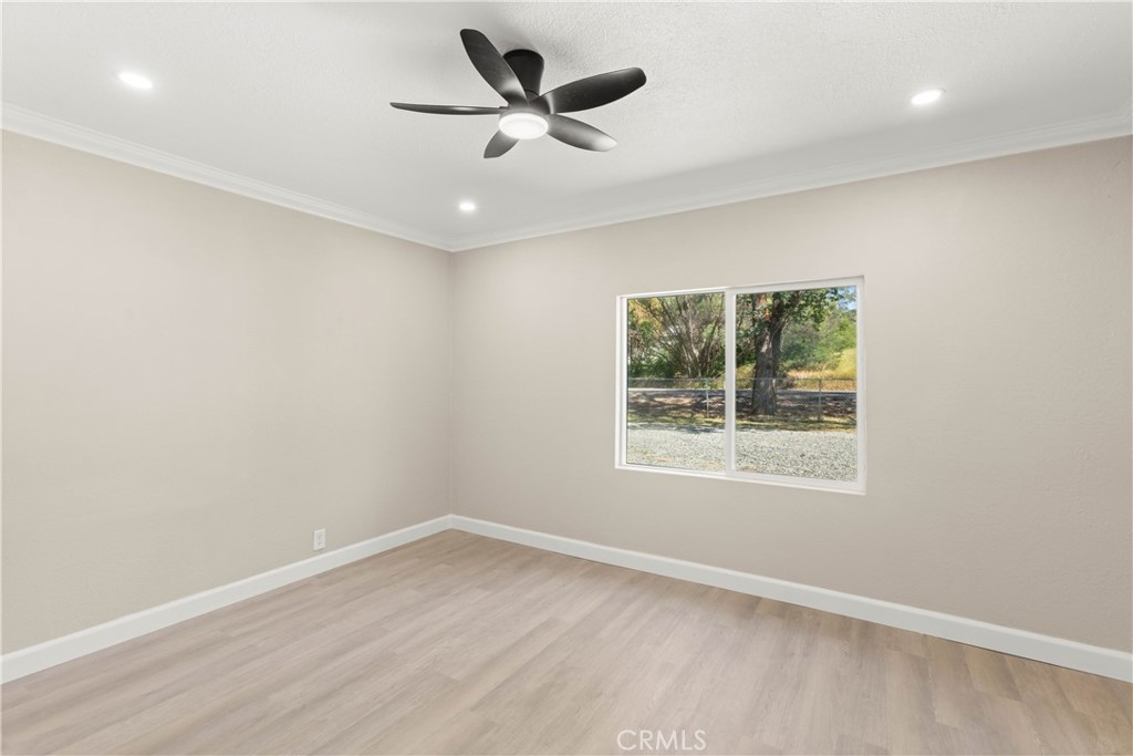 4936 Lower Wyandotte Road Oroville, CA 95966 - Photo 16 of 41 an empty room with a window and a fan