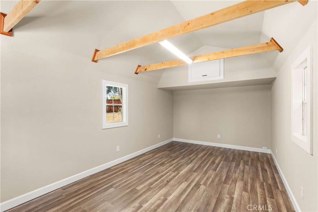 4936 Lower Wyandotte Road Oroville, CA 95966 - Photo 34 of 41 an empty room with wooden floor and windows