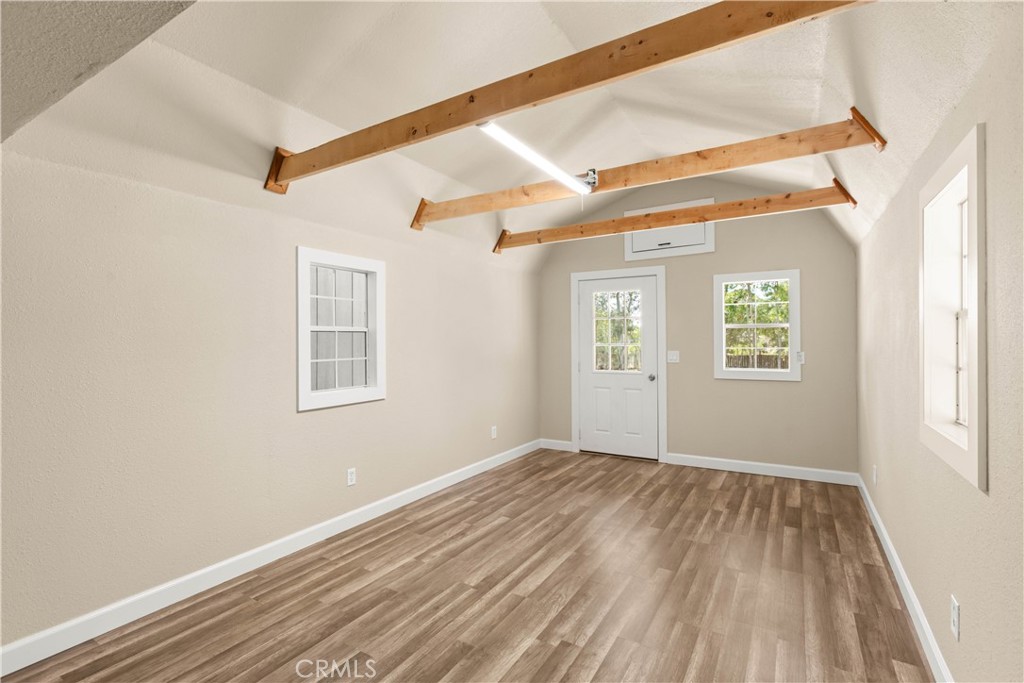 4936 Lower Wyandotte Road Oroville, CA 95966 - Photo 35 of 41 a view of an empty room with wooden floor and a window